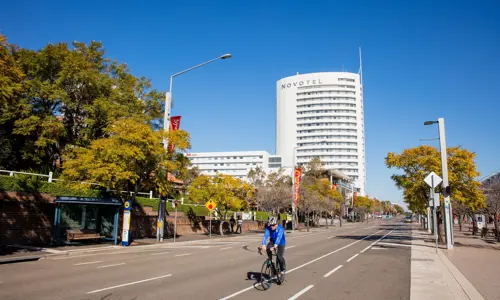 road view with Novotel Sydney Olympic Park in background