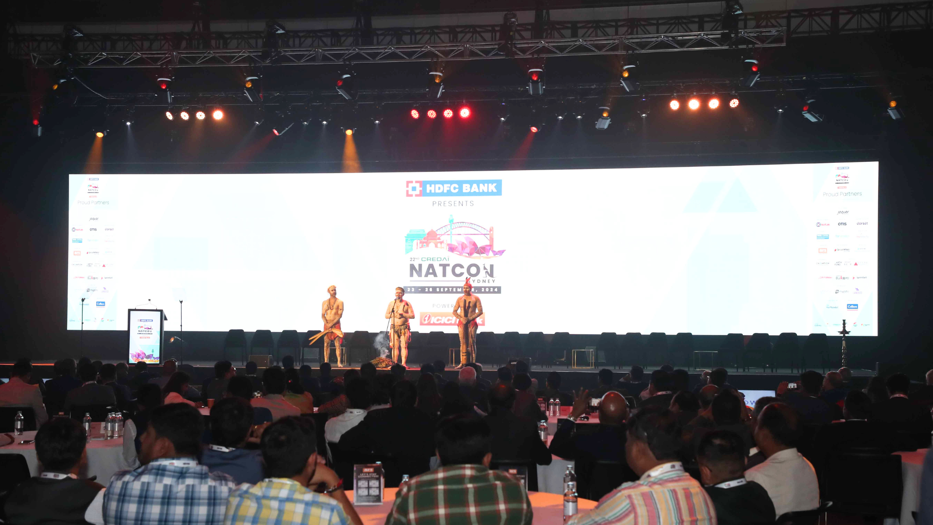 three First Nations performers on stage at the Credai Natcon event
