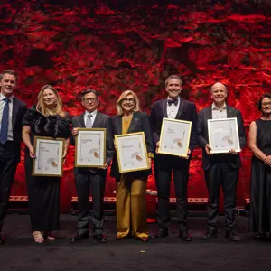 Group photo of the 2026 new BESydney Ambassadors on stage with Premier Chris Minns and BESydney CEO Amanda Lampe