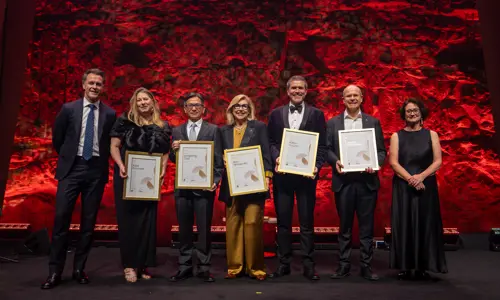 Group photo of the 2026 new BESydney Ambassadors on stage with Premier Chris Minns and BESydney CEO Amanda Lampe