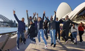 Incentive group gathered outside Sydney Opera House with views of Sydney Harbour Bridge in the background