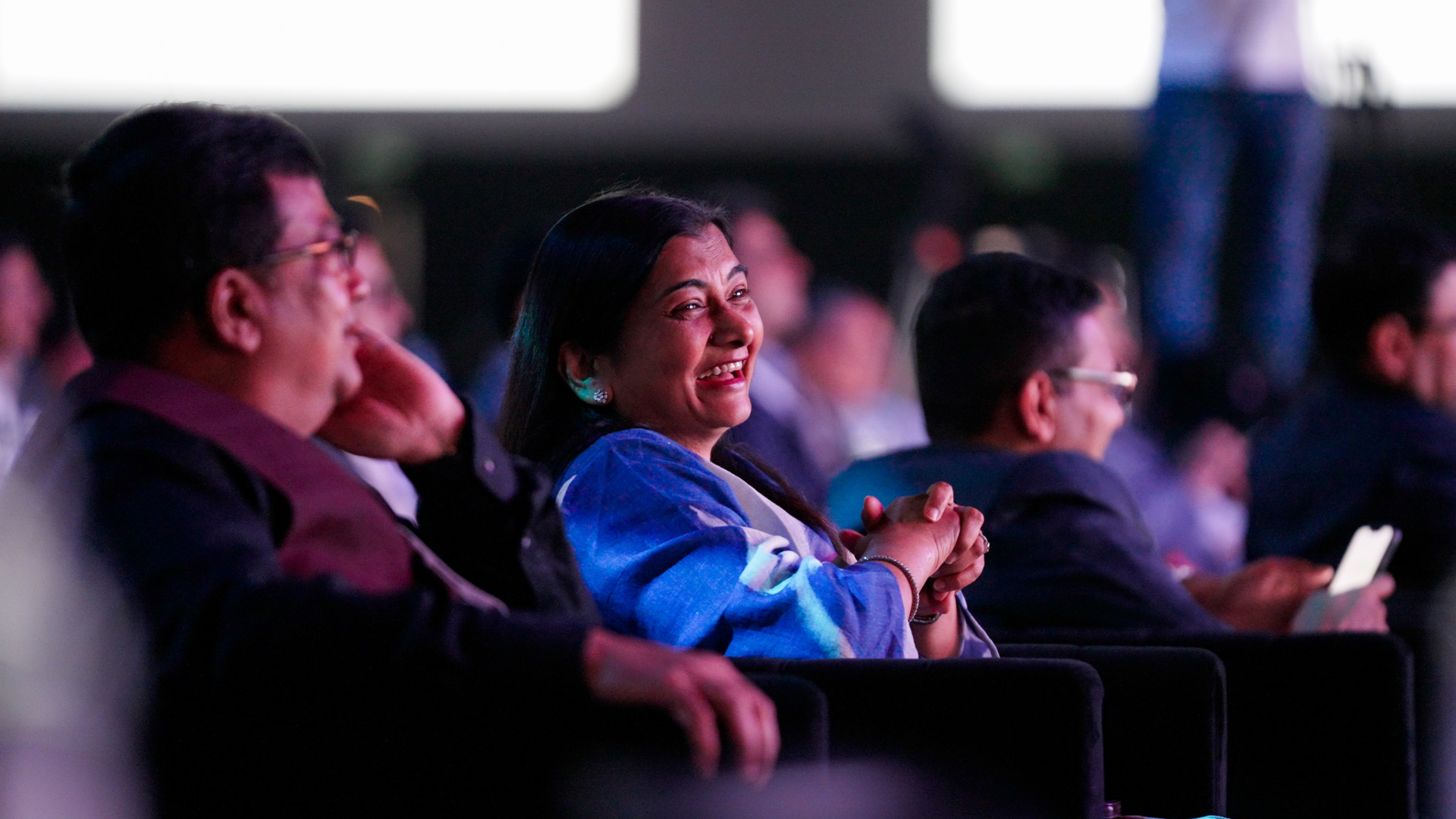 Close up view of smiling delegates seated at the Credai Natcon event 