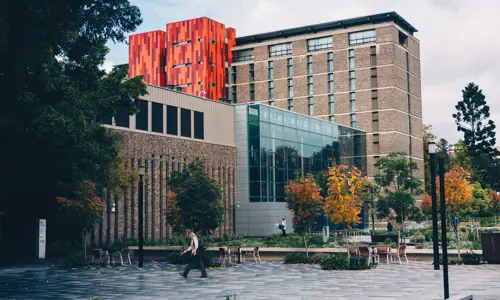 Macquarie University with person walking by, a photo by Fidel Fernando US