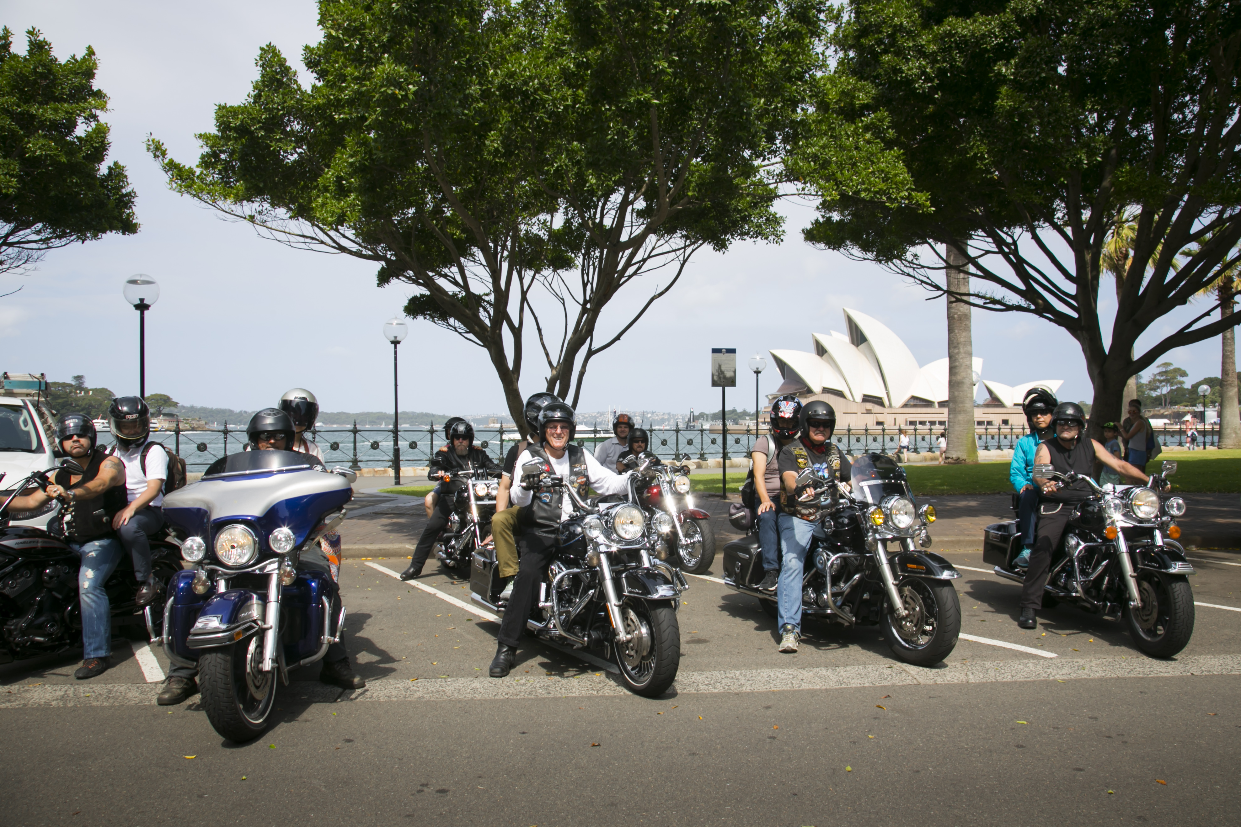 Two rows of Harley Motorbike riders in front of Sydney Harbour and Sydney Opera House