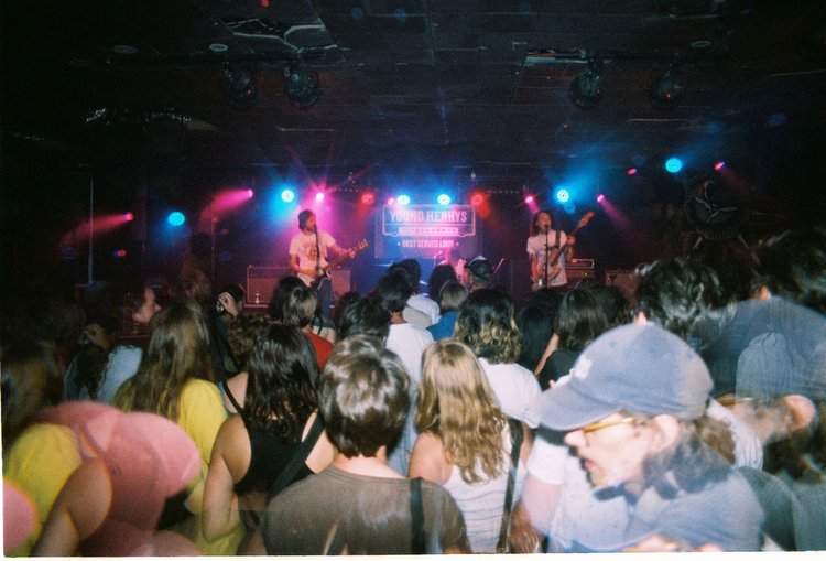 Band on stage with crowd on the dance floor at Young Henrys
