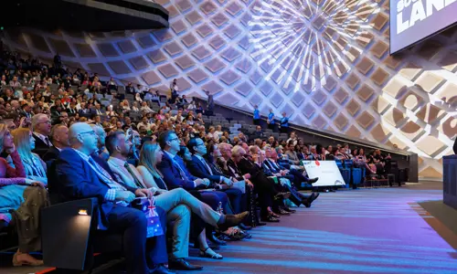 Large Audience Seated In Auditorium At An Opening Ceremony