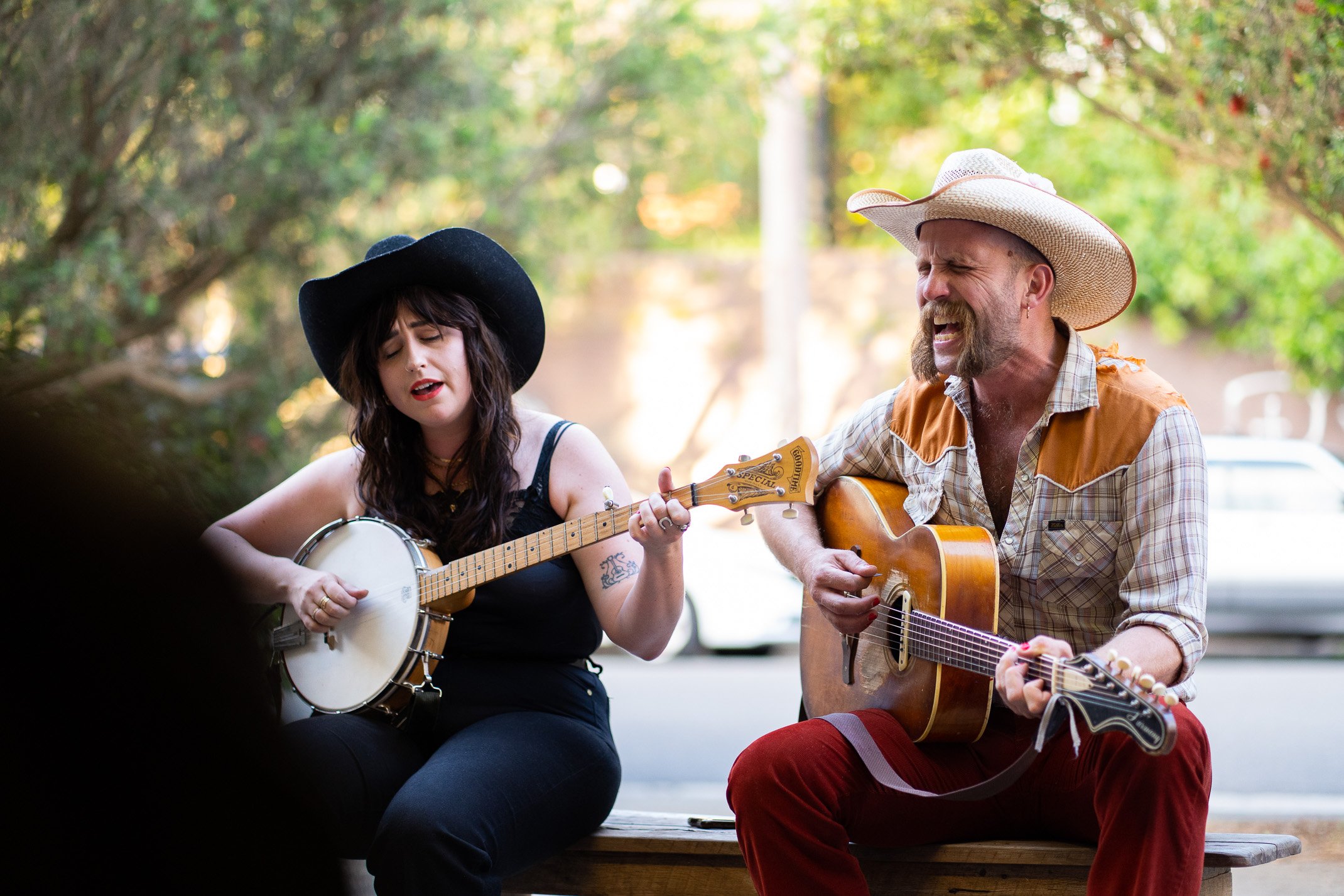 Two musicians playing a guitar and banjo at Young Henrys