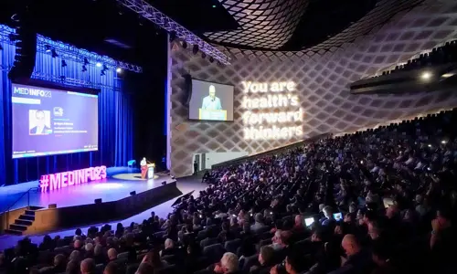 Health conference with large audience watching stage