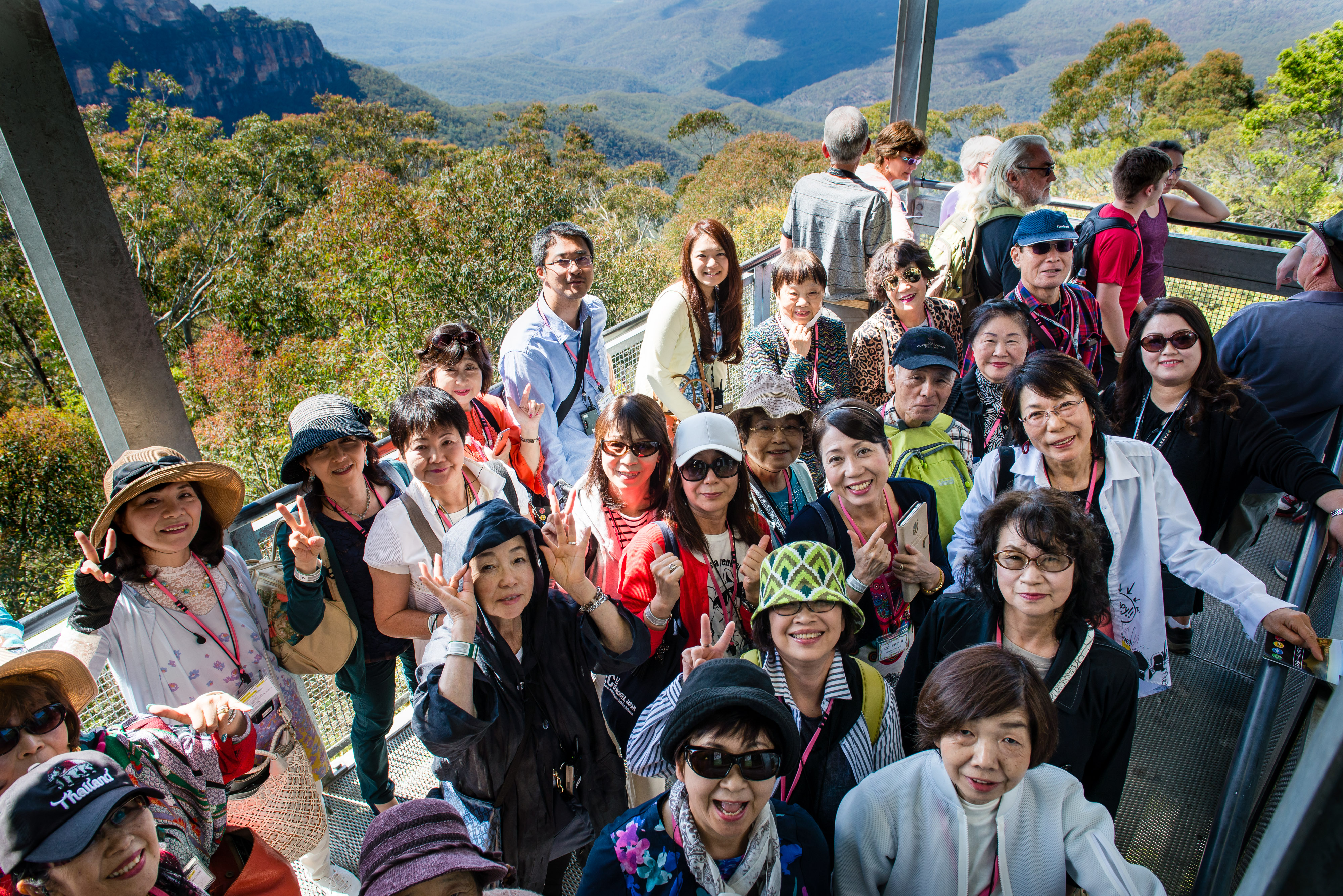 Smiling group of Japanese visitors take photo from Blue Mountains scenic view