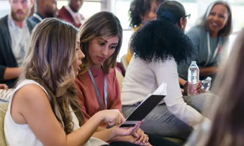 Women at conference reading program