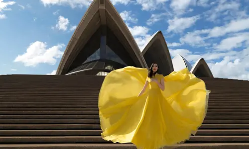 A performer in yellow dress at the steps of the Sydney Opera House