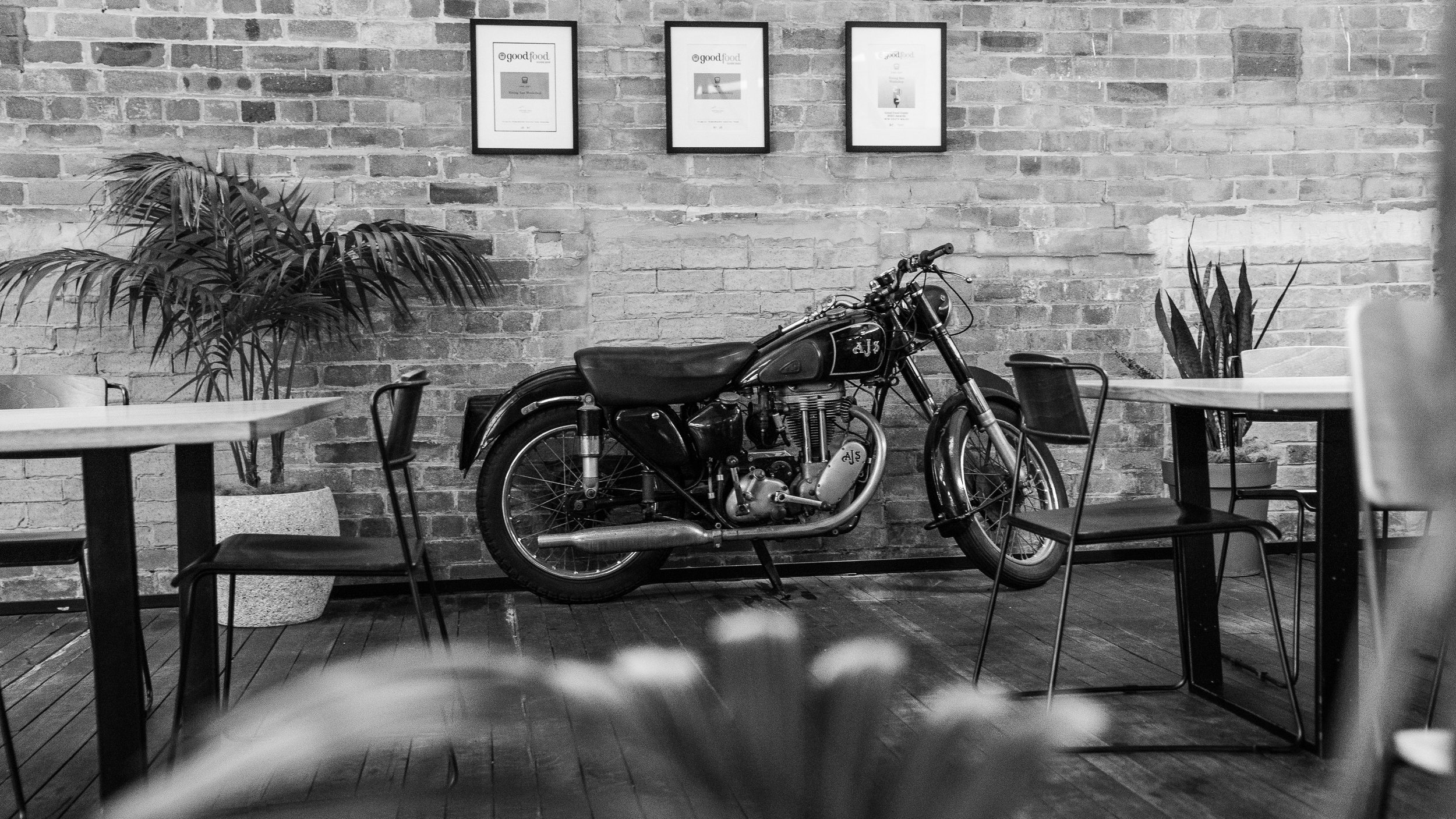 Interior shot of motorbike again brick wall at Young Henrys