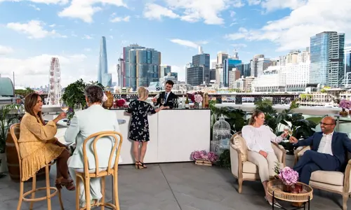 Guests enjoying networking drinks at Darling Harbour Rooftop Bar