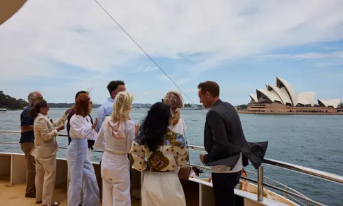 Affluent individuals on ferry looking at Sydney Opera House