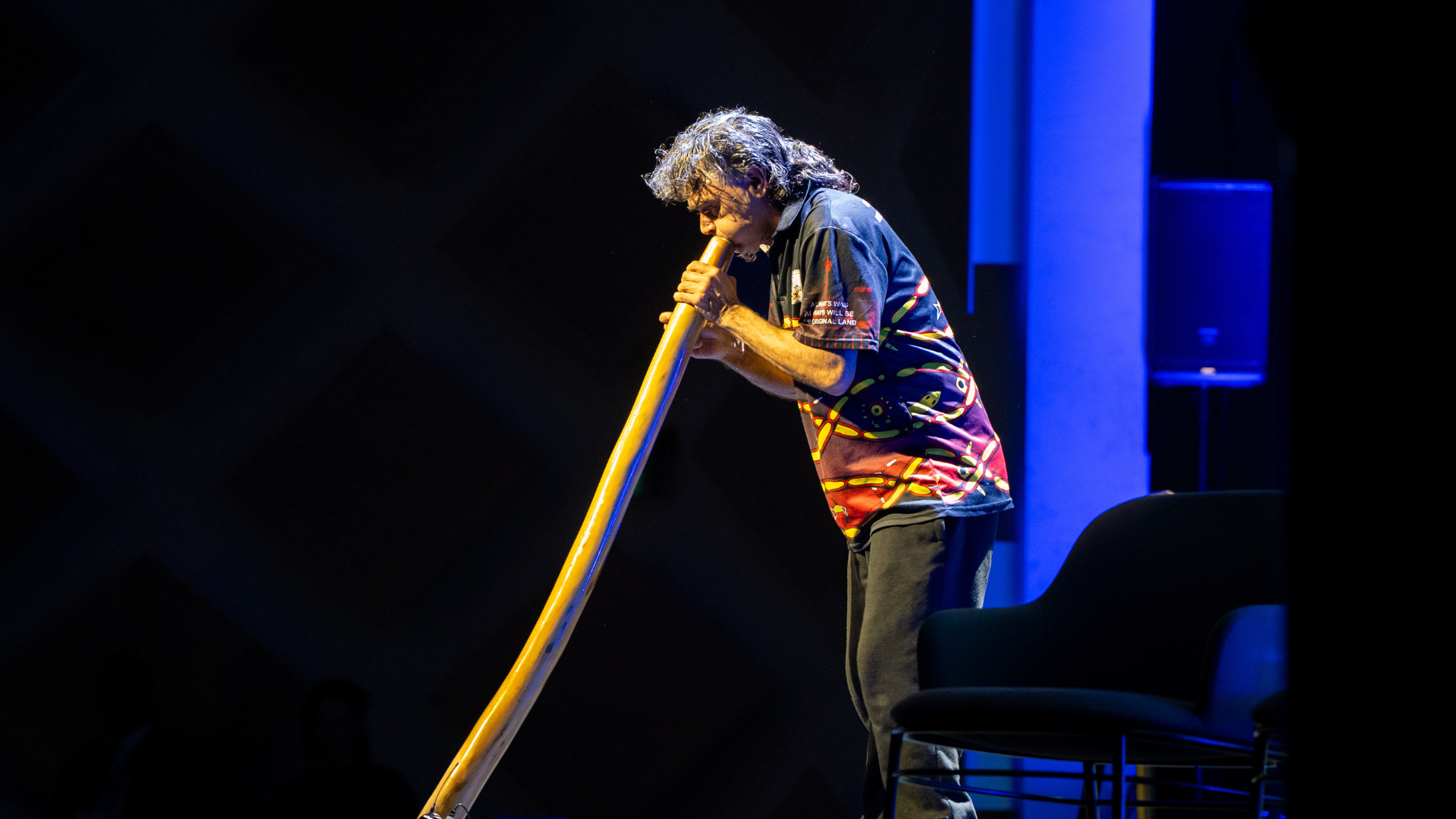 Man playing the Didgeridoo as part of the First Nations ceremony