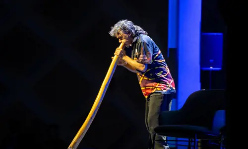 Man playing the Didgeridoo as part of the First Nations ceremony