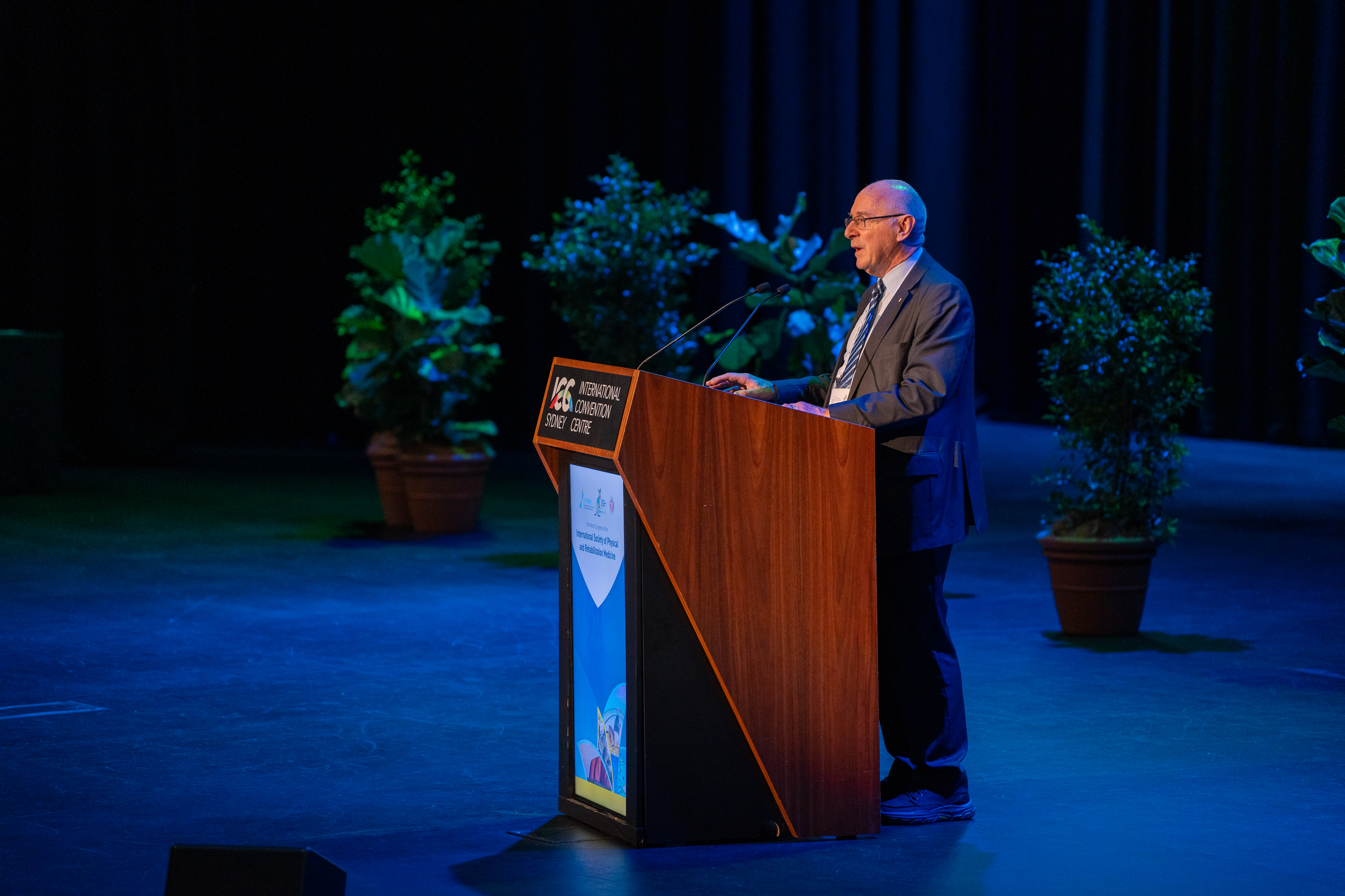 ISPRM World Congress presenter on stage addressing audience
