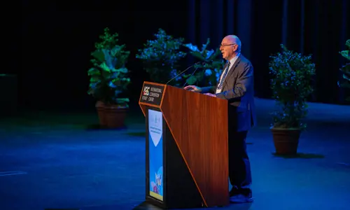 ISPRM World Congress presenter on stage addressing audience
