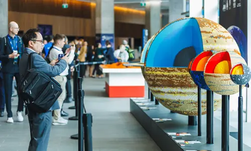 International Astronautical Congress 2025 Attendees Interact With Lego Planet Exhibit