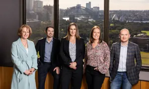 About Us Besydney Team Photo In Boardroom Harbour Background