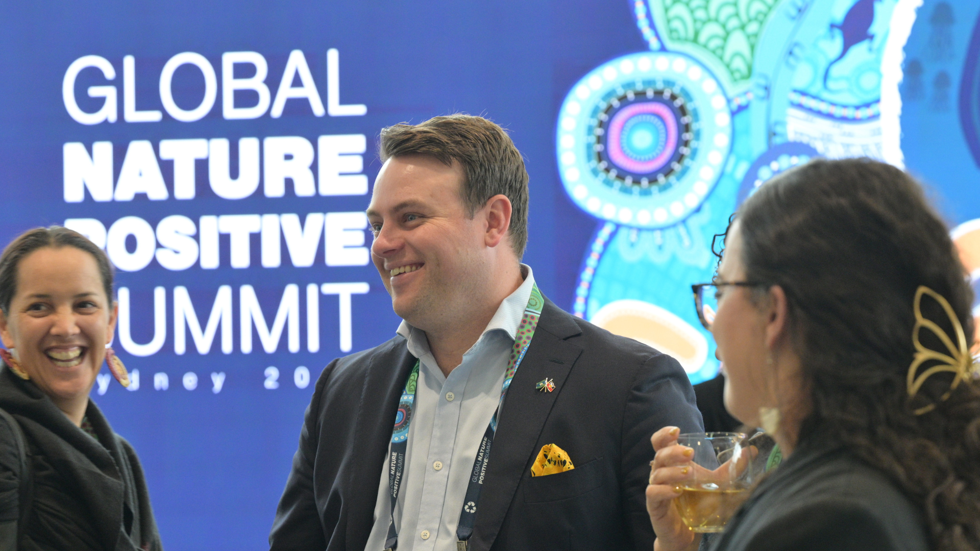 Three Delegates Interacting On Expo Floor at the Global Nature Positive Summit