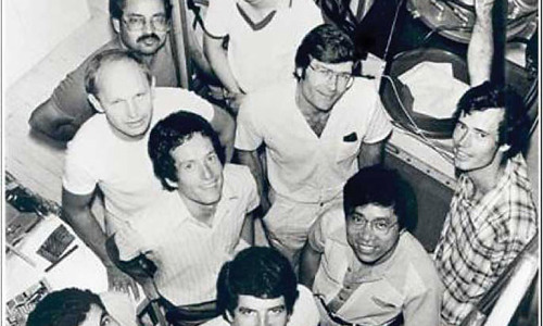 Professor Martin Green, inventor of PERC solar cells, is standing with his research team in an image from the 1980s
