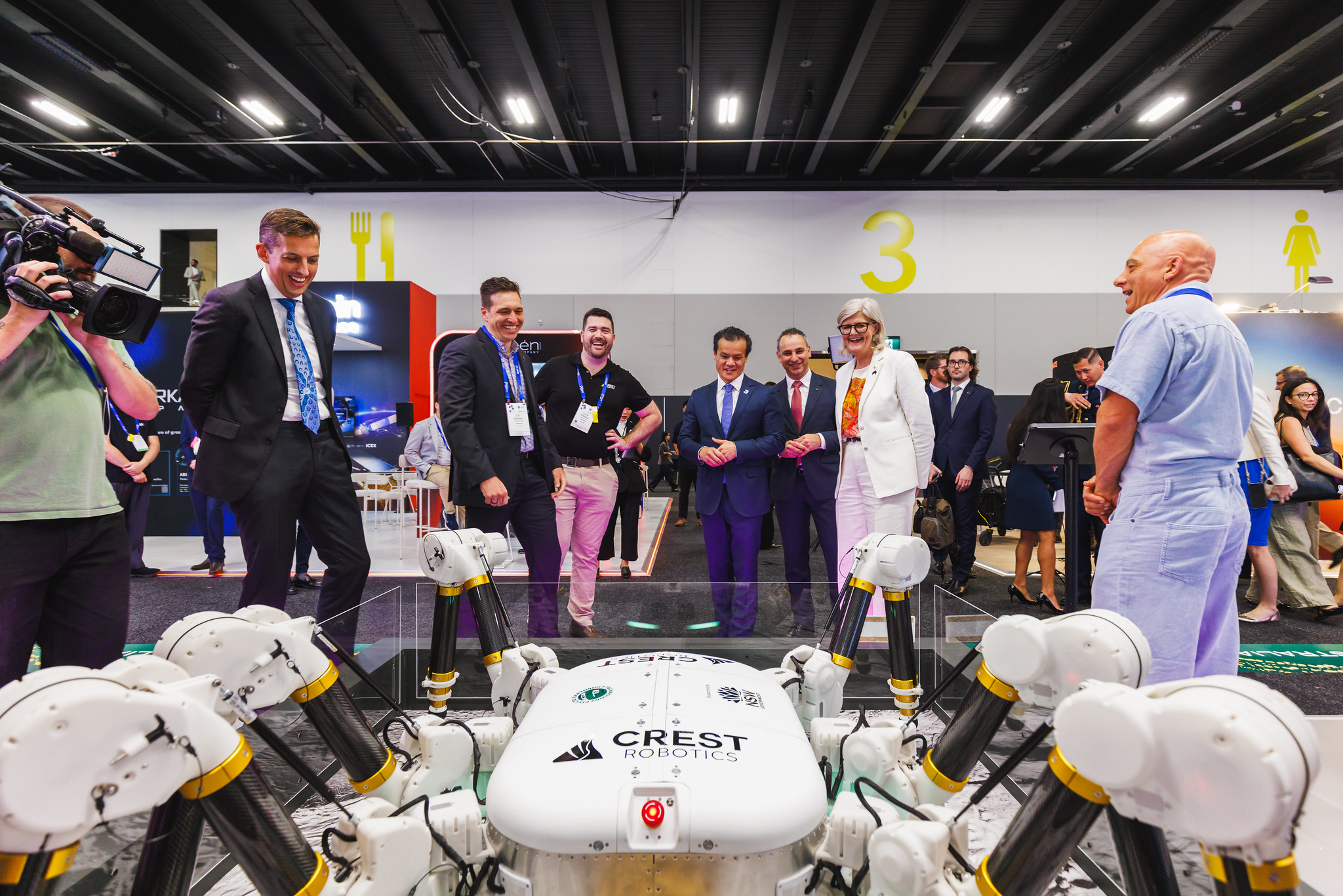 International Astronautical Congress 2025 Group Of Exhibit Attendees Looking At Prototype