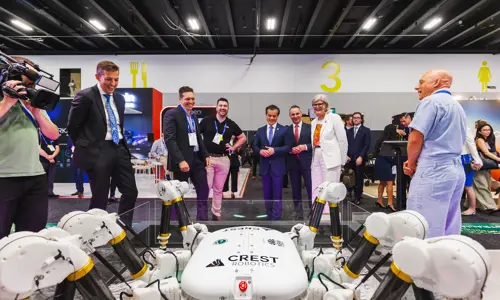 International Astronautical Congress 2025 Group Of Exhibit Attendees Looking At Prototype